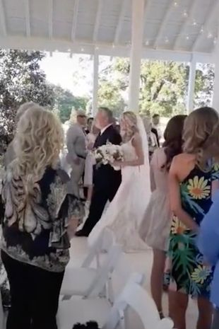 The bride and her dad walking down the aisle