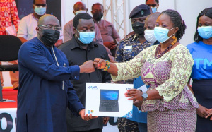 Vice President Bawumia hands over a laptop to the first beneficiary of the initiative