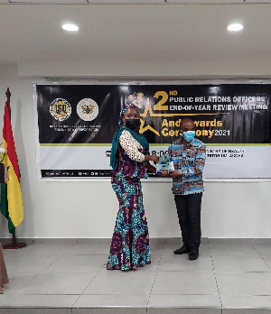 Otabil receiving his award from the Deputy Minister of Information