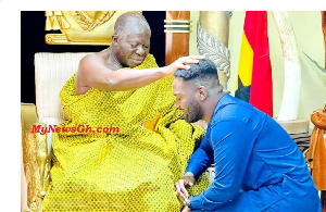 Asantehene, Otumfuo Osei Tutu II laying his hand on the doctor