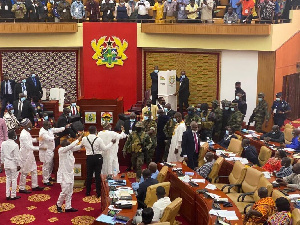 Military men moving to the floor of parliament