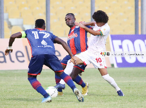 Asante Kotoko midfielder, Fabio Gama(White) in action against Legon Cities