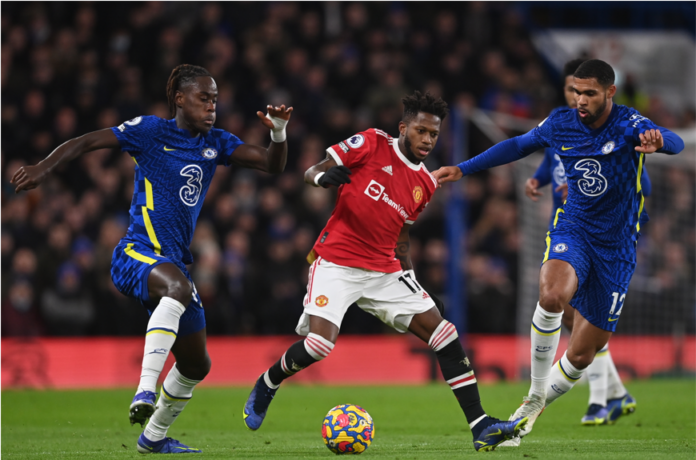 Manchester United's Fred (C) in action against Chelsea players Trevoh Chalobah (L) and Ruben Loftus-Cheek (R)