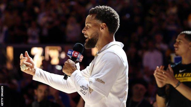 Curry speaks to the crowd during the Warriors' ring ceremony