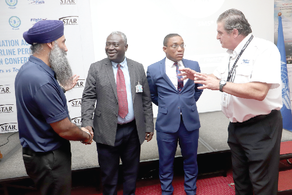  Capt Jonathan Kordich (right), Executive Vice- President, Star Navigation Systems Group, briefing  Akwasi A. Prempeh (2nd from right), Commissioner of AIB Ghana, after the opening session  of the conference. With them are Harmeet Gill (left), Senior Director of Investor Relations, Star Navigation, and Daniel Acquah (2nd from left), a Deputy Director, Ghana Civil Aviation Authority. Picture: SAMUEL TEI ADANO