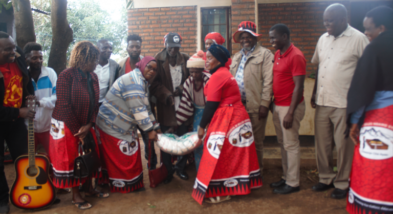 Chiwanja Cha Ayao members cheer musician Giddes Chalamanda