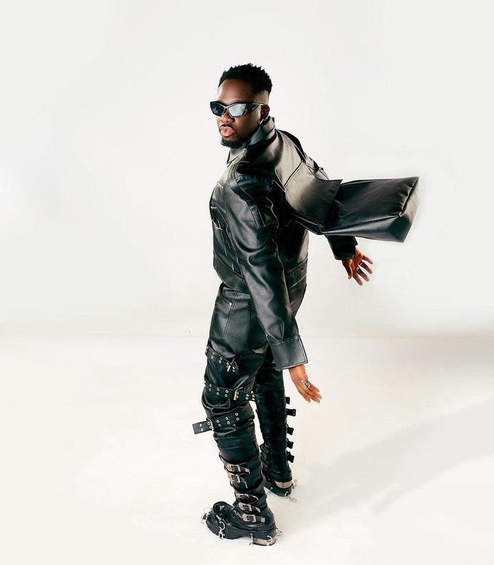 His outfit was completed with black leather boots and a statement silver helmet, evoking a futuristic, almost sci-fi look