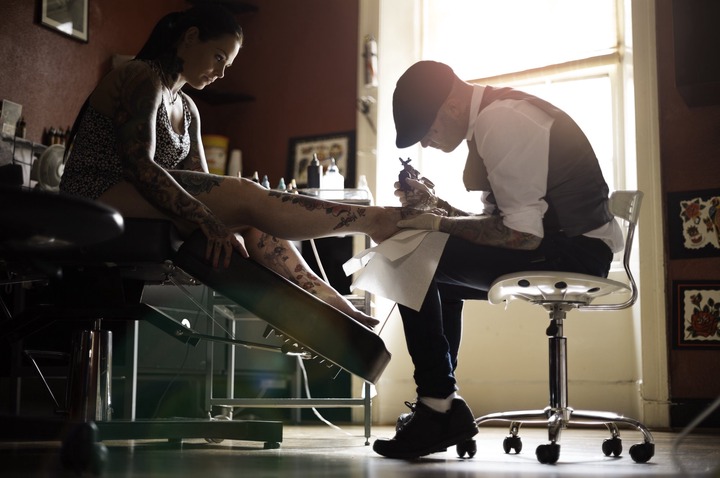 Woman getting their foot tattooed