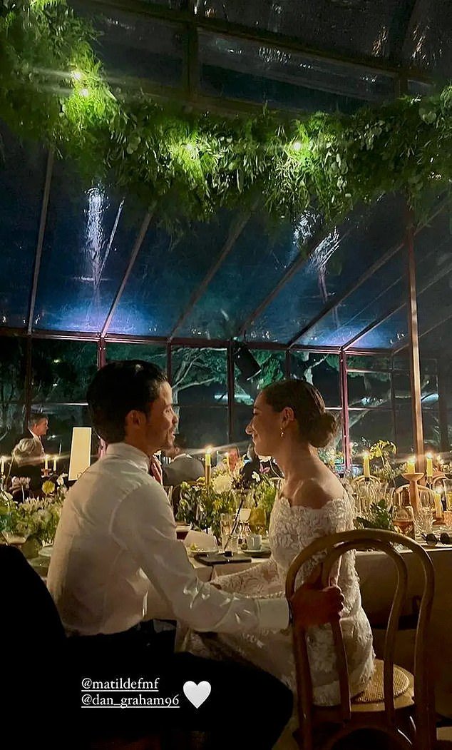 Matilde and Danny were also snapped gazing lovingly into each others eyes at their reception dinner, with tables seen laden with candles and plants, while the glass ceiling was adorned with hanging vines