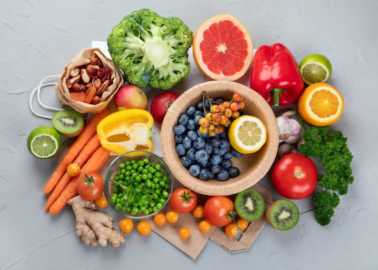 Foods high in vitamin C. Food rich in antioxidant, fiber, carbohydrates. Boost immune system and brain; balances cholesterol; promotes healthy heart. Top view, copy space , with chalkboard , with empty notebook