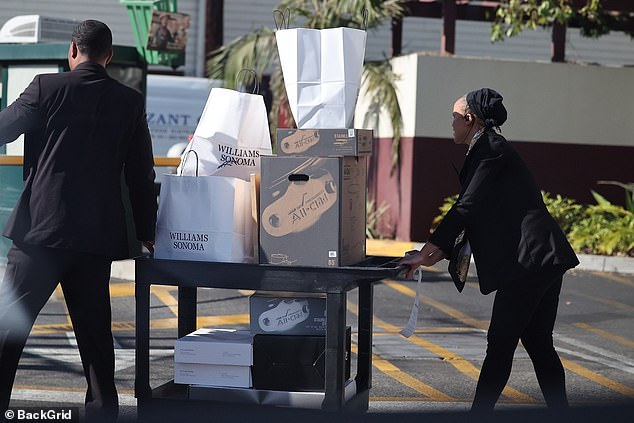 Two people were pictured wheeling the packed shopping cart