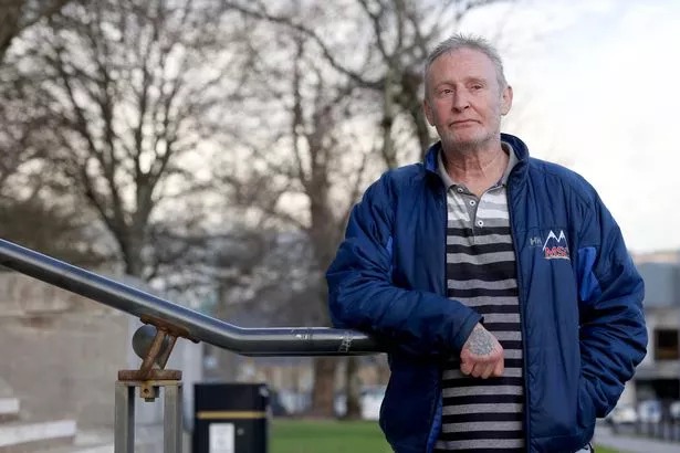 Man leaning against handrail